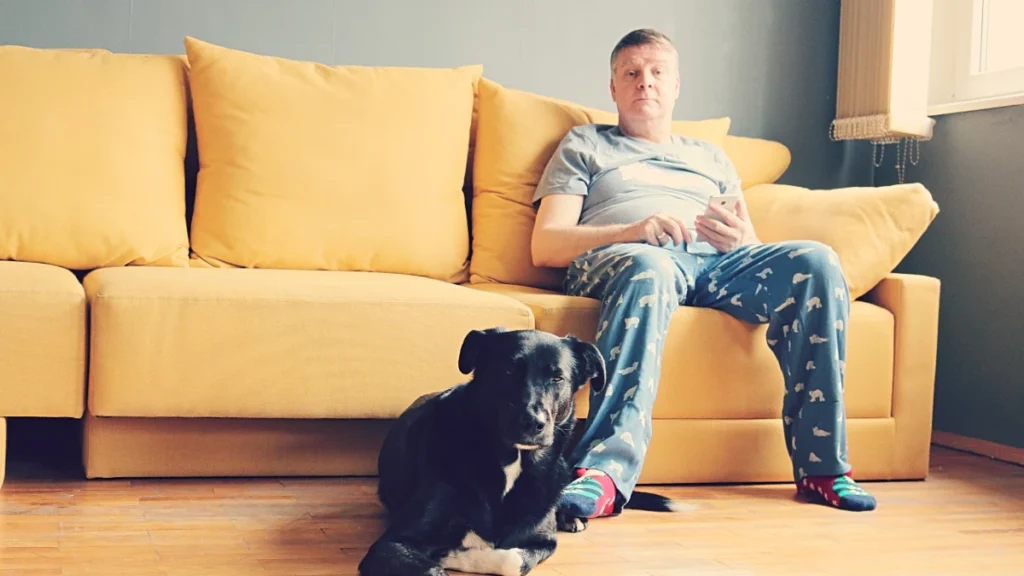 elderly old man home sofa with his pet dog