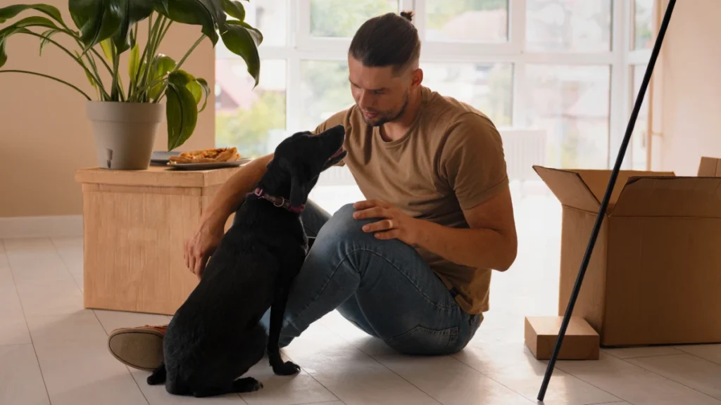 happy man moving his new home with his dog