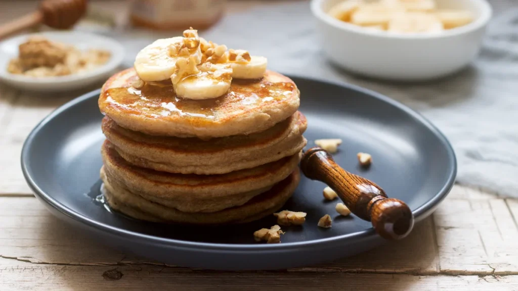 pancakes with banana nuts honey served with tea rustic style